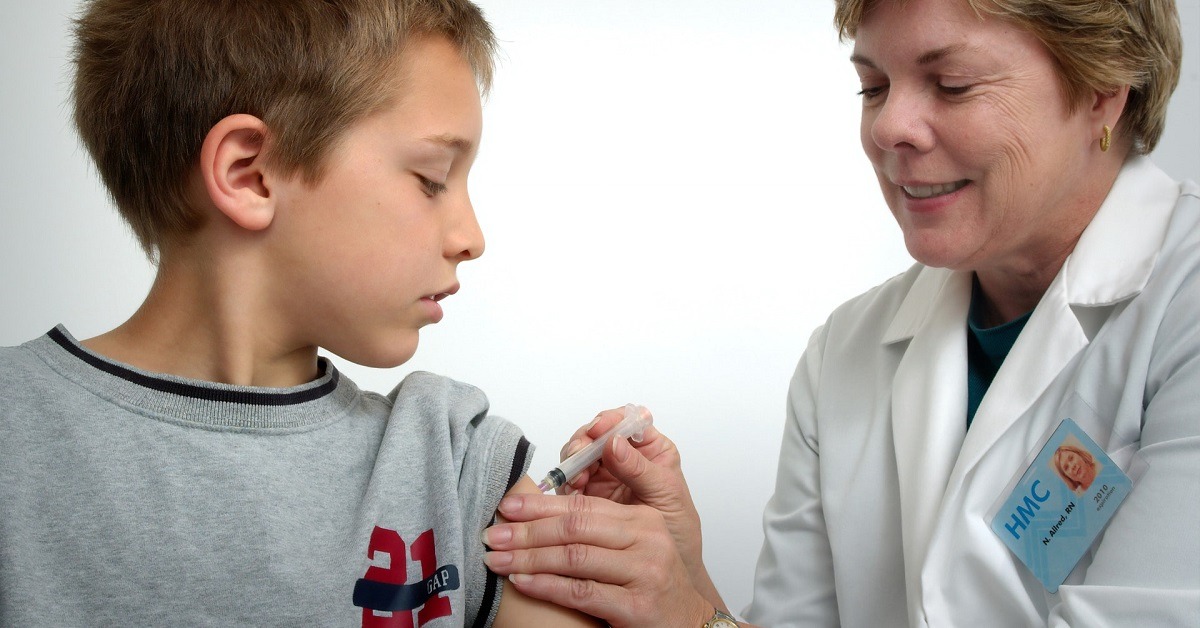 A pharmacist administering tetanus vaccine in Birmingham to a child