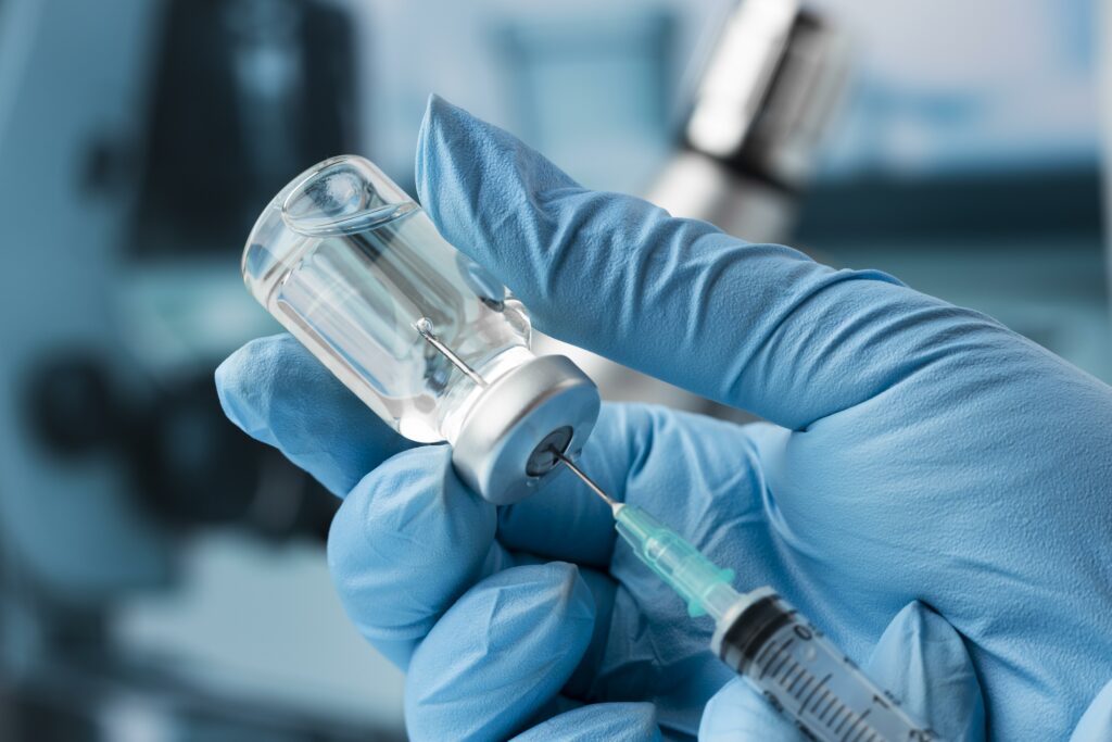 Vaccine being retrieved from vial into needle