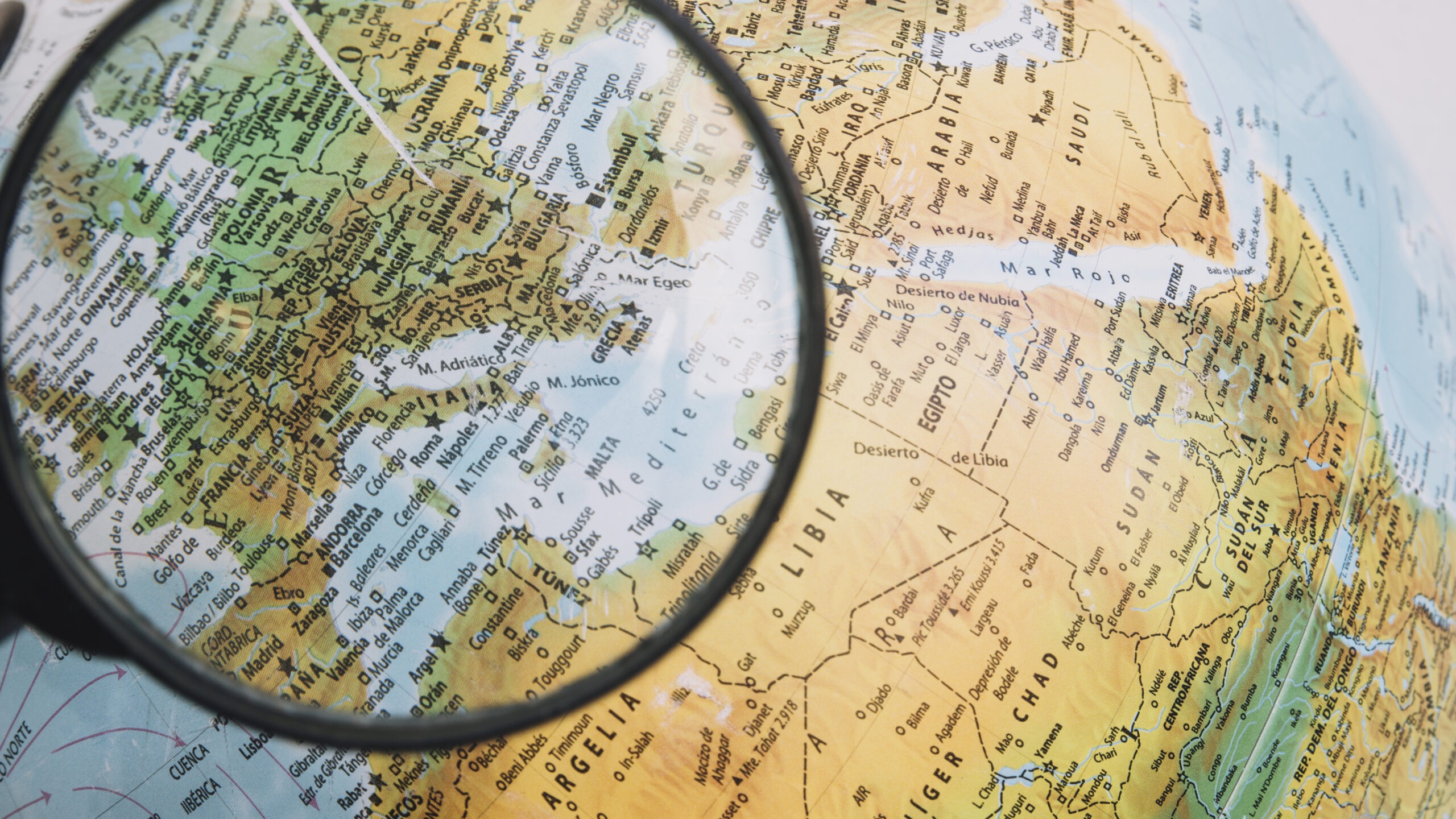 Magnifying glass on a map of the globe